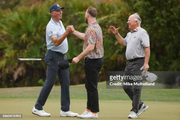 Matt Kuchar of the United States shakes hands with Shaun O'Meara, son of Mark O'Meara on the ninth green during the first round of the PNC...