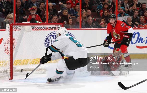 Craig Anderson of the Ottawa Senators watches as Tommy Wingels of the San Jose Sharks taps in a rebound to score a goal as Kyle Turris of the Ottawa...