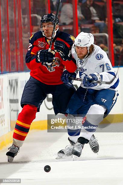 Tomas Kopecky of the Florida Panthers tangles with Pierre-Cedric Labrie of the Tampa Bay Lighting at the BB&T Center on October 27, 2013 in Sunrise,...