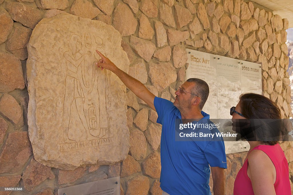 Man pointing out symbolism in wall mural