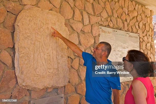 Man Pointing Out Symbolism In Wall Mural, 照片檔