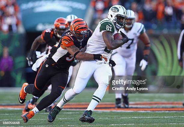 Jeff Cumberland of the New York Jets runs with the ball while defended by Michael Boley of the Cincinnati Bengals during the game at Paul Brown...