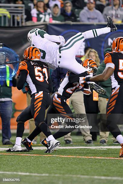 Jayson DiManche and Brandon Ghee of the Cincinnati Bengals up ends quarterback Matt Simms of the New York Jets during their game at Paul Brown...