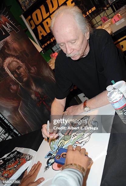 Director John Carpenter sign copies of his first comic book "Asylum" held at Golden Apple Comics on October 27, 2013 in Los Angeles, California.