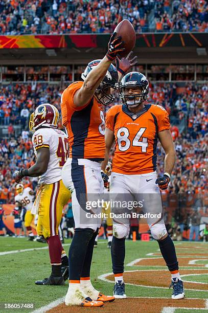 Tight ends Joel Dreessen and Jacob Tamme of the Denver Broncos celebrate a fourth quarter Dreessen touchdown at Sports Authority Field Field at Mile...