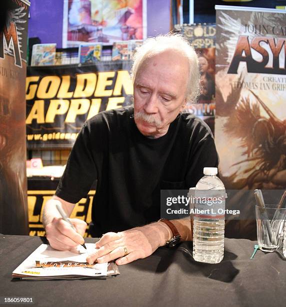 Director John Carpenter sign copies of his first comic book "Asylum" held at Golden Apple Comics on October 27, 2013 in Los Angeles, California.