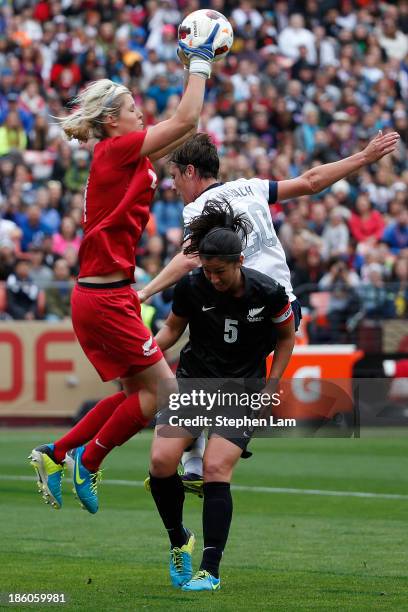 Goalkeeper Erin Nayler of New Zealand catches the ball as teammate Abby Erceg battles with forward Abby Wambach of the U.S. Women's National Team...