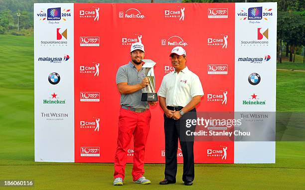 Ryan Moore of the United States poses for photographs with the Deputy Prime Minister of Malaysia, Tan Sri Muhyiddin Yassin after the playoff with...