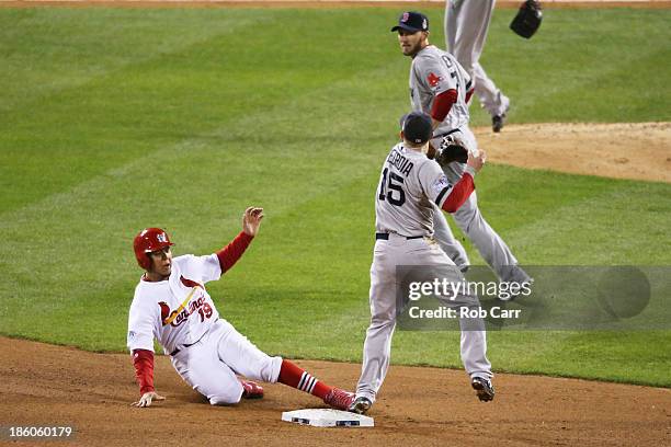 Jon Jay of the St. Louis Cardinals gets tagged out at second base by Dustin Pedroia of the Boston Red Sox after David Freese hit grounder into...