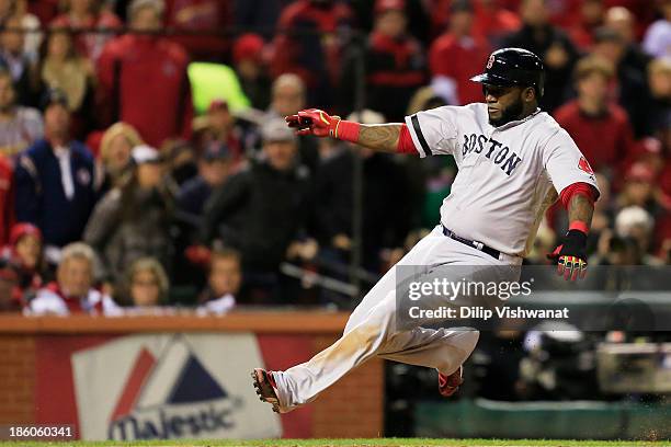 David Ortiz of the Boston Red Sox slides safe into home plate on a sacrifice fly to left field hit by teammate Stephen Drew against Lance Lynn of the...