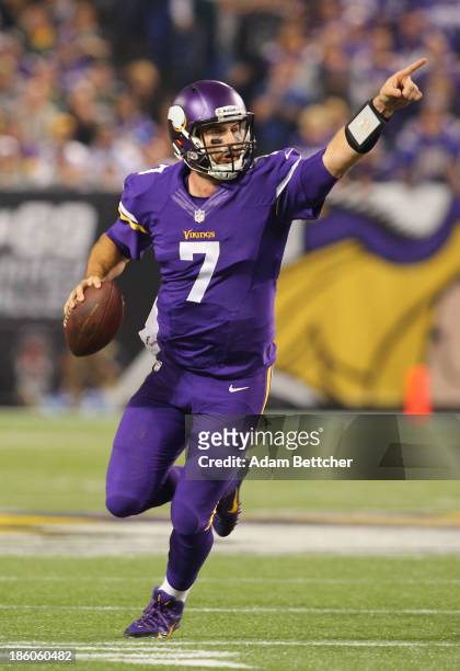 Christian Ponder of the Minnesota Vikings signals to his teammates against the Green Bay Packers on October 27, 2013 at Mall of America Field at the...