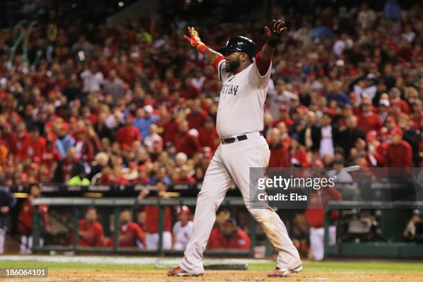 David Ortiz of the Boston Red Sox celebrates scoring a run after sliding safe into home plate on a sacrifice fly to left field hit by teammate...