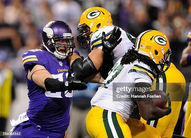 Don Barclay of the Green Bay Packers defends against Brian Robison of the Minnesota Vikings as Eddie Lacy of the Green Bay Packers runs past with the...