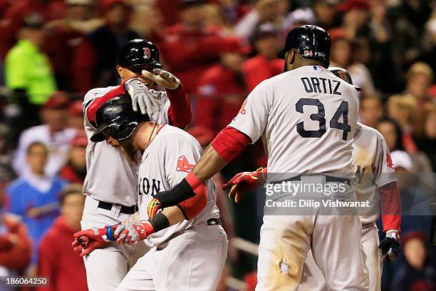 Jonny Gomes of the Boston Red Sox celebrates with teamates David Ortiz Xander Bogaerts and Dustin Pedroia after hitting a three run home run to left...