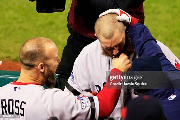 David Ross of the Boston Red Sox pulls teammate Jonny Gomes beard after hitting a three run home run to left field against Seth Maness of the St....