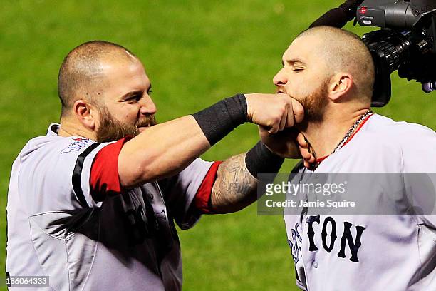 Mike Napoli of the Boston Red Sox pulls teammate Jonny Gomes beard after hitting a three run home run to left field against Seth Maness of the St....