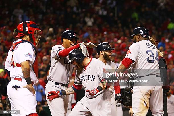 Jonny Gomes of the Boston Red Sox celebrates with teamates David Ortiz Xander Bogaerts and Dustin Pedroia after hitting a three run home run to left...