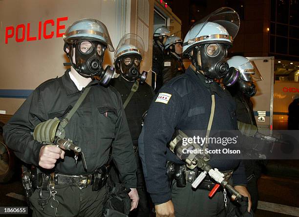 Police in riot gear stand ready with pepper spray at an anti-war protest on March 20, 2003 in Chicago, Illinois. Several thousand protestors marched...