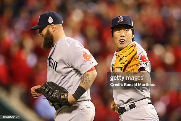 Koji Uehara of the Boston Red Sox celebrates with teammate Mike Napoli after defeating the St. Louis Cardinals in Game Four of the 2013 World Series...