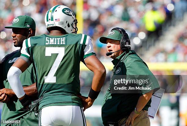 Geno Smith of the New York Jets talks with offensive coordinator Marty Mornhinweg during a game against the New England Patriots on October 20, 2013...