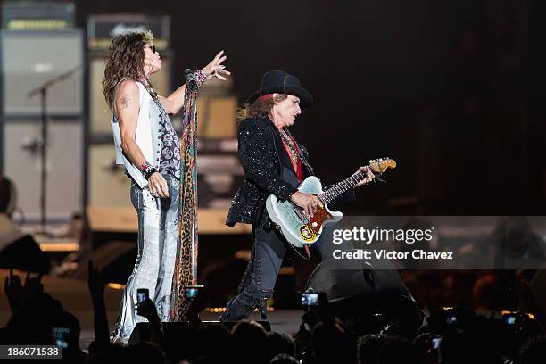 Singer Steven Tyler and Joe Perry of Aerosmith perform on stage at Arena Ciudad de México on October 27, 2013 in Mexico City, Mexico.