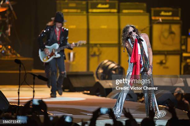 Joe Perry and singer Steven Tyler of Aerosmith perform on stage at Arena Ciudad de México on October 27, 2013 in Mexico City, Mexico.