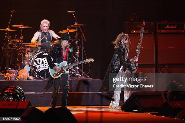 Joey Kramer, Steven Tyler and Joe Perry of Aerosmith perform on stage at Arena Ciudad de México on October 27, 2013 in Mexico City, Mexico.