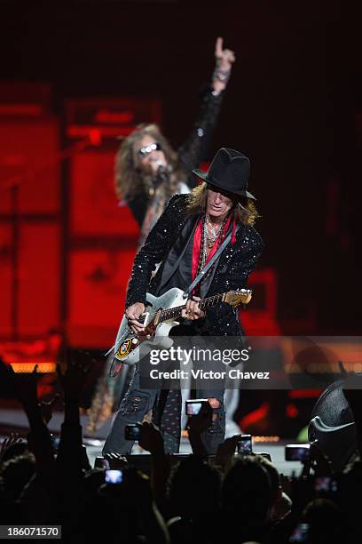 Joe Perry and singer Steven Tyler of Aerosmith perform on stage at Arena Ciudad de México on October 27, 2013 in Mexico City, Mexico.