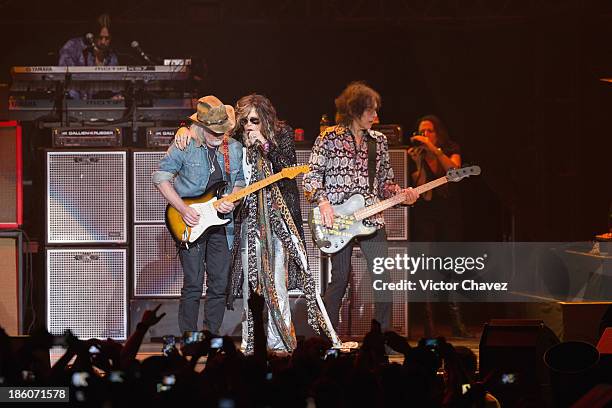 Tom Hamilton and singer Steven Tyler of Aerosmith perform on stage at Arena Ciudad de México on October 27, 2013 in Mexico City, Mexico.