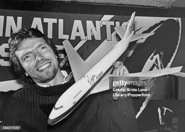 British businessman Richard Branson holding a model Boeing 747 at a press conference for the launch of his Virgin Atlantic airline, London, 29th...