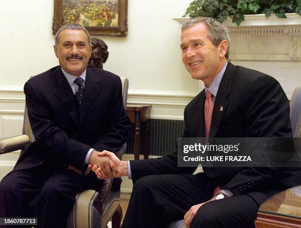 President George W. Bush shakes hands with the President of Yemen, Ali Abdallah Saleh before meetings 27 November, 2001 in the Oval Office at the...