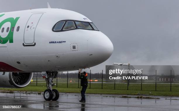 This photograph taken on December 19 shows a view of an Airbus 321neo aircraft from Transavia arriving at Schiphol Airport. This type of Airbus...