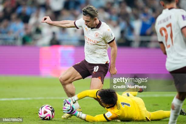 Jack Grealish left winger of Manchester City and England and Shusaku Nishikawa Goalkeeper of Urawa Red and Japan compete for the ball during the FIFA...