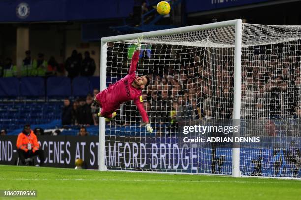 Newcastle United's Slovakian goalkeeper Martin Dubravka dives to stop the ball during the English League Cup quarter-final football match between...