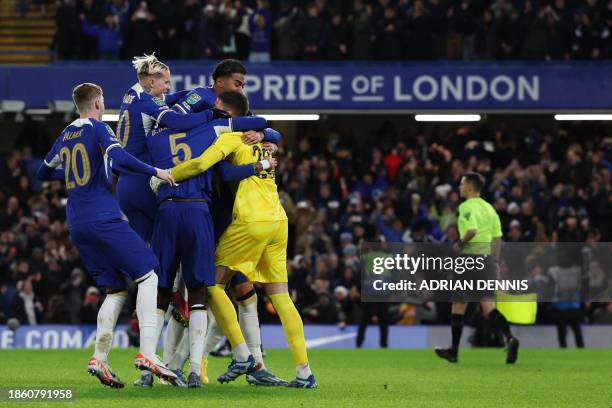 Chelsea's Serbian goalkeeper Djordje Petrovic celebrates with teammates after saving the last penalty during the penalty shoot out to win the English...