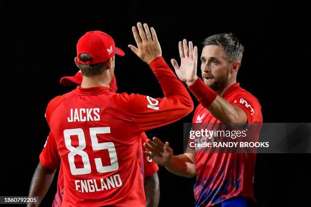 Chris Woakes of England celebrates the dismissal of Shai Hope of the West Indies with Will Jacks during the 4th T20I between the West Indies and...