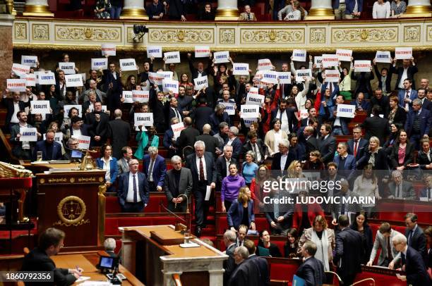 Left-wing coalition NUPES members of parliament hold signs reading "Liberte", "Egalite", "fraternite" French for 'liberty, equality, fraternity', the...