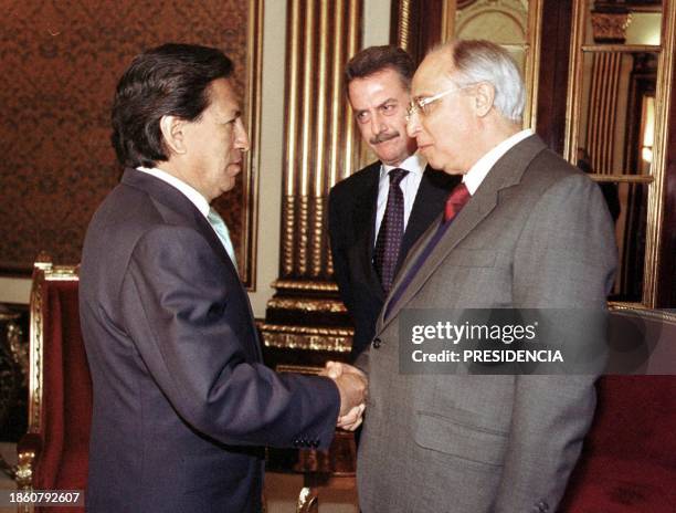 Brazilian defense minister, Geraldo Magela da Cruz , and his Peruvian counterpart Aurelio Loret de Mola , greet President Alejandro Toledo at the...