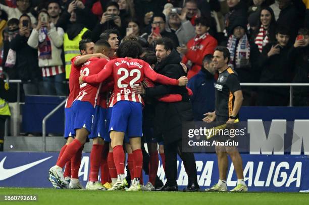 Antoine Griezmann of Atletico Madrid celebrates with head coach Diego Simeone after scoring a goal during La Liga week 18 football match between...