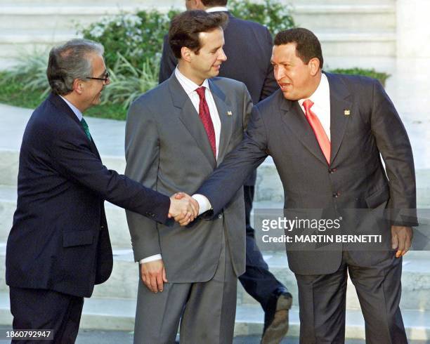 Colombian President Andres Pastrana, greets Venezuelan President Hugo Chavez, as Bolivian President Jorge Quiroga stands by during ceremonies for a...