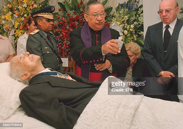 Priest blesses the body of former Dominican Republic president Joaquin Balaguer, 15 July 2002, in Santo Domingo. Balaguer, who held sway over...