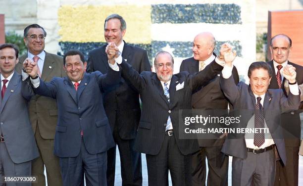 The Presidents of Bolivia, Jorge Quiroga, of Venezuela Hugo Chavez, of Ecuador Ricardo Noboa, and of Argentina Eduardo Duhalde, hold hands during a...