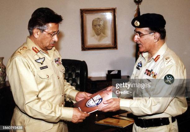 Pakistani President Pervez Musharraf receives the first annual report -2001 of National Accountability Bureau from Lieutenant General Munir Hafiez,...