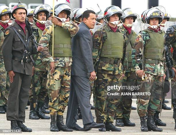 Venezuelan President Hugo Chavez, checks military officials of the National Guard, during a ceremony that took place in Caracas, 28 June 2002....