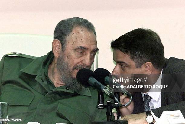 President Fidel Castro speaks with Felipe Perez Roque, 22 April 2002 in Habana, during a conference about the meeting between Castro and Mexican...