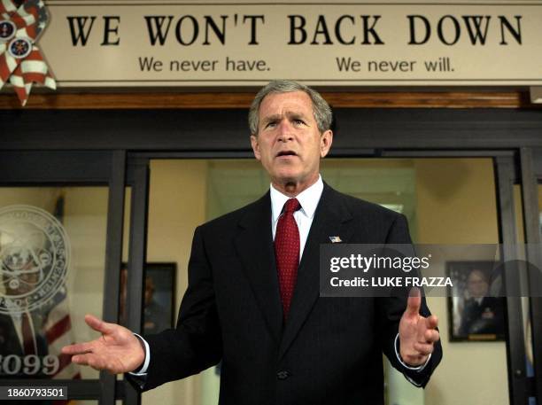 President George W. Bush answers reporters' questions after walking out of the National Security Operations Center at the National Security Agency 04...