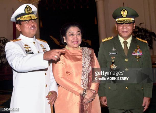 Indonesian president Megawati Sukarnoputri , incoming Indonesia's armed forces chief General Endriartono Sutarto and outgoing Indonesian armed forces...