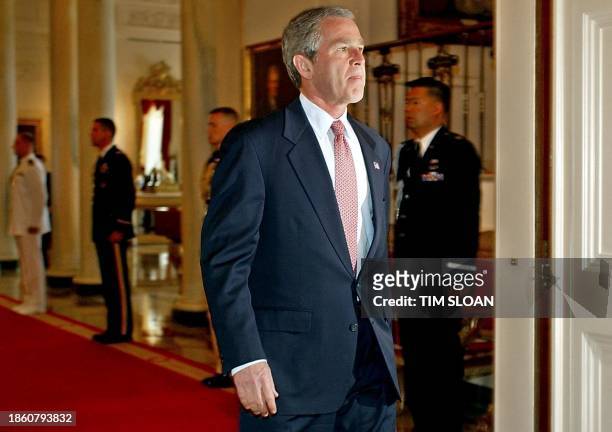 President George W. Bush enters the East Room of the White House House to make a speech on his administrations policy toward Cuba 20 May 2002 in...