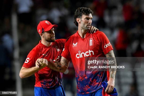 Chris Woakes and Reece Topley of England celebrate winning the 4th T20I between the West Indies and England at Brian Lara Cricket Academy Stadium in...