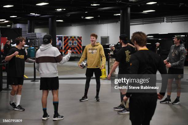 Mason Lohrei of the Boston Bruins smiles while warming up playing soccer with his team mates before the game against the Minnesota Wild on December...